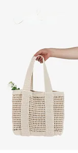Detail of hollow woven cotton tote bag with spacious interior and crochet design
