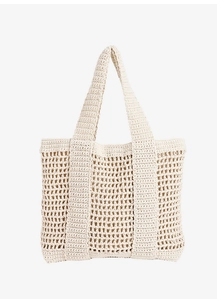 Detail of off-white crochet tote bag showing hollow mesh design and sturdy woven handles