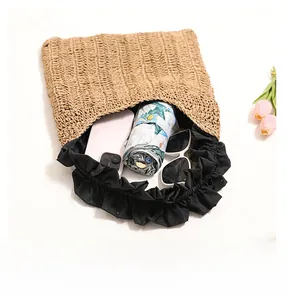 Detailed view of the straw bag spacious interior holding phone, umbrella and sunglasses