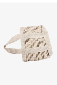 Detail of cream crochet beach bag featuring large hollow mesh weave and sturdy handles