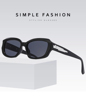 Detail of black square sunglasses with grey lenses and silver metal temple accents