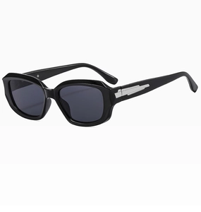 Detail view of glossy black sunglasses featuring retro large frames and silver metal accents