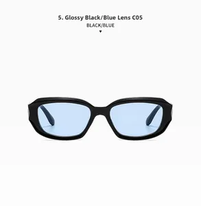 Detail view of oval retro sunglasses with glossy black frame and light blue lenses
