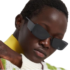 Close-up of semi-rimless cat-eye sunglasses featuring sleek black lenses and thick temples