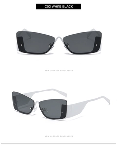Detail of futuristic white and black cat-eye sunglasses with wide frames and metal rivets