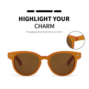 Detailansicht der matten orangefarbenen ovalen Sonnenbrille mit silbernen Nieten