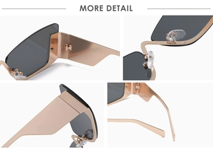 Detail view of cat eye sunglasses showing rose gold metal frame and wide geometric temples