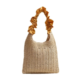 Japanese style straw woven tote bag with bright yellow ruffled handle for beach vacation