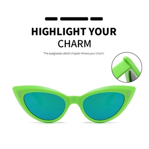 Detailed view of green cat-eye sunglasses featuring silver rivets and hinge construction