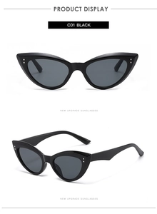 Detail view of black cat-eye sunglasses with silver rivet accents and dark lenses