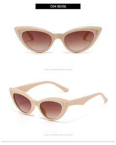 Detail view of beige cat-eye sunglasses featuring silver studs and brown gradient lenses