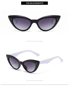 Detail view of cat eye sunglasses with black frame white temples and silver rivets