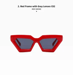 Detail view of bold red geometric cat-eye sunglasses with gradient grey lenses and glossy finish