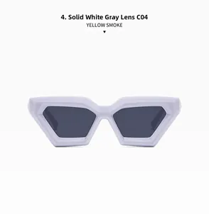 Detail view of solid white chunky cat-eye sunglasses with grey lenses and sharp geometric frame