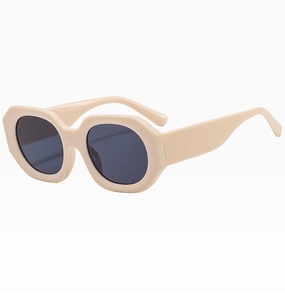 Detailed close-up of chunky cream beige geometric sunglasses with dark lenses