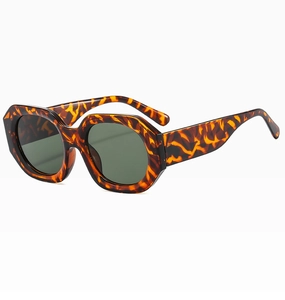 Detail view of tortoiseshell geometric sunglasses with wide temples and dark green lenses