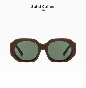 Macro shot of thick solid coffee geometric sunglasses frame with deep grey lenses