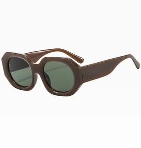 Close-up of chunky dark brown irregular polygonal sunglasses frame with green lenses
