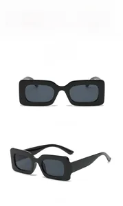 Front and side view of trendy black rectangular sunglasses with grey lenses