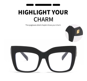 Detail of oversized black square glasses with gold metal hinge accents and clear lenses