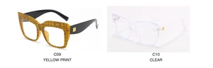 Detail of square oversized glasses frames C09 yellow print and C10 clear with gold metal accents