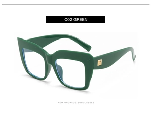 Detail view of oversized green square glasses frame with golden metal hinges and blue lenses