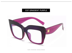 Detail of oversized purple gradient sunglasses with gold hardware and CE mark on temple