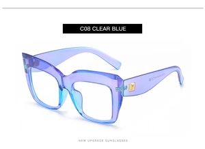 Detail view of large square frame glasses in clear blue finish with gold metal temple accent