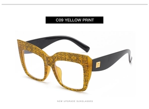 Detail of yellow leopard print frames with gold square metal accents on temples