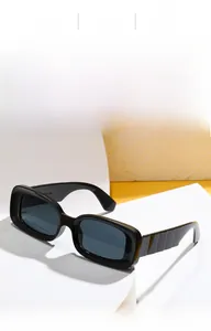 Detail view of stylish square sunglasses featuring thick black frames and textured temples