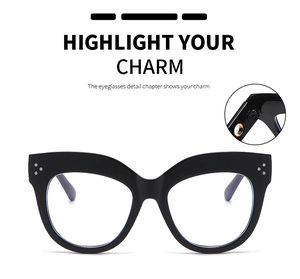 Detailed close-up of thick black cat-eye eyeglass frames with triple metal rivet accents