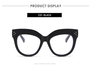 Front view of stylish black oversized cat-eye glasses with silver rivet details.