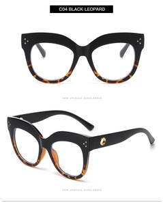 Detail of cat-eye frames in C04 Black Leopard with gold metal ring and rivet accents