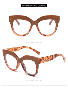 Detail of cat eye glasses in brown red leopard finish with gold hinge accents
