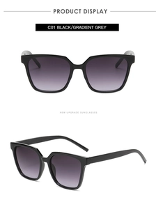 Macro detail of glossy black square sunglasses frames with gradient purple lenses