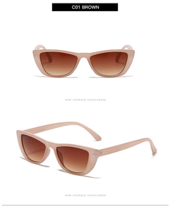 Detail view of pink cat eye sunglasses with gradient brown lenses and brand logo