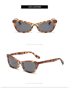 Detail view of cat eye sunglasses featuring vintage leopard print frame and grey lenses
