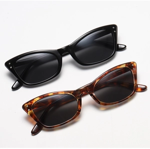 Detail of vintage cat-eye sunglasses in black and tortoiseshell with silver stud accents