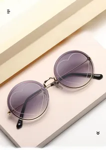 Detail of round rimless sunglasses with gradient lenses and heart-shaped engraving