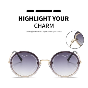 Macro view of gold metal hinge and purple gradient round lens with heart design