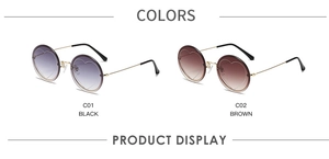 Detail view of round rimless sunglasses with heart accents in black and brown gradient lenses