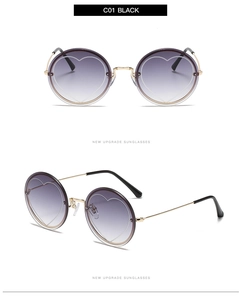 Detail view of round rimless sunglasses with purple gradient lenses and heart patterns