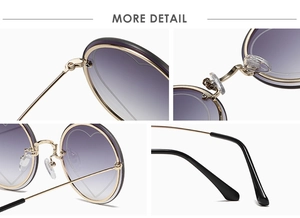 Detail of round rimless sunglasses featuring purple gradient lenses and heart-shaped accents