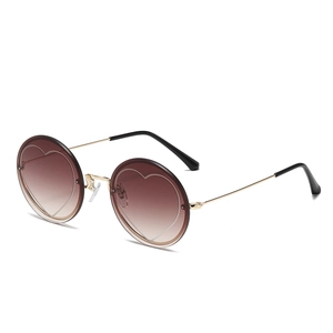 Fashionable round rimless sunglasses for women with gold frame and heart detail