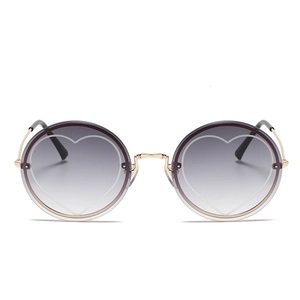 Fashionable rimless round sunglasses with gold metal frame and heart pattern gradient lens