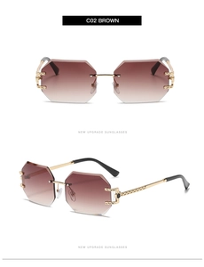 Close-up of frameless rimless sunglasses with brown gradient lenses and gold metal temples