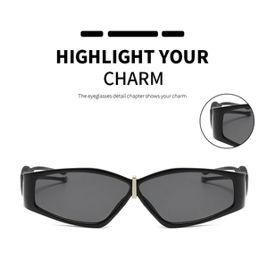 Detail view of black geometric sunglasses featuring a stylish golden metal bridge accent