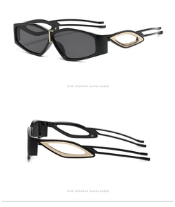 Detail of black sunglasses featuring triple-strand hollow temples and gold metal accents