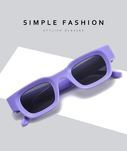 Detail of purple rectangular frames and dark lenses on futuristic Y2K sunglasses
