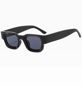 Close-up of thick rectangular black frames on vintage square sunglasses with gray lenses